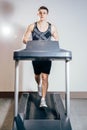 Handsome man doing cardio exercises, running on treadmills in the gym Royalty Free Stock Photo