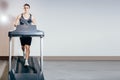 Handsome man doing cardio exercises, running on treadmills in the gym Royalty Free Stock Photo