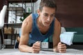 Handsome man doing plank exercise on floor at home Royalty Free Stock Photo