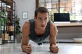 Handsome man doing plank exercise on floor at home Royalty Free Stock Photo