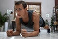 Handsome man doing plank exercise on floor at home Royalty Free Stock Photo