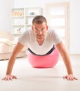 Handsome man doing push ups on the gym ball Royalty Free Stock Photo