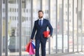 Handsome man doing shopping in the city. Businessman man carrying grocery shopping bags after work in evening walking