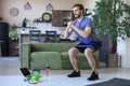 Handsome man doing squats exercise at home during quarantine. Concept of healthy life Royalty Free Stock Photo