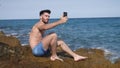 Handsome man doing videochat at sea