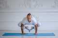 Handsome man doing yoga pose  on a white background Royalty Free Stock Photo