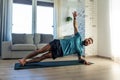 Handsome man doing yoga, stretching, resting after home workout, New Year& x27;s resolutions, exercising as healthy Royalty Free Stock Photo