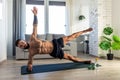 Handsome man doing yoga, stretching, resting after home workout, New Year& x27;s resolutions, exercising as healthy Royalty Free Stock Photo