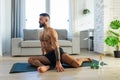 Handsome man doing yoga, stretching, resting after home workout, New Year& x27;s resolutions, exercising as healthy Royalty Free Stock Photo