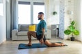 Handsome man doing yoga, stretching, resting after home workout, New Year's resolutions, exercising as healthy Royalty Free Stock Photo