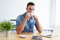 Handsome man drinking coffee in the office Royalty Free Stock Photo