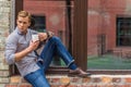 Handsome man drinking coffee outside of office building Royalty Free Stock Photo