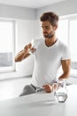 Handsome Man Drinking Glass Of Fresh Water Indoors In Morning Royalty Free Stock Photo