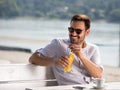 Smiling man enjoying in cafe in beach Royalty Free Stock Photo