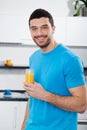 Handsome man drinking orange juice Royalty Free Stock Photo