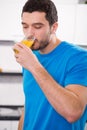 Handsome man drinking orange juice Royalty Free Stock Photo