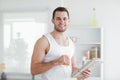 Handsome man drinking orange juice while reading the news Royalty Free Stock Photo