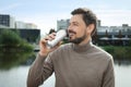 Handsome man drinking from tin can near river Royalty Free Stock Photo