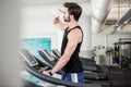 Handsome man drinking water on treadmill Royalty Free Stock Photo