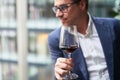 Handsome man drinking wine. Selective focus. Royalty Free Stock Photo