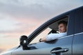 Handsome man driving his modern car, low angle view Royalty Free Stock Photo