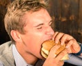 Handsome Man eating Cheeseburger Royalty Free Stock Photo