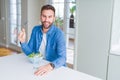 Handsome man eating green peas at home Royalty Free Stock Photo