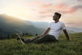 Handsome man enjoying beautiful mountain landscape at sunset Royalty Free Stock Photo