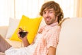 Handsome man enjoying a glass of wine on the couch Royalty Free Stock Photo