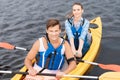 Handsome man enjoying sport activity while rowing in canoe