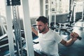 Handsome Man is Exercising With Lifting Machine in Fitness Club.,Portrait of Strong Man Doing Working Out Calories Burning in Gym Royalty Free Stock Photo