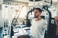 Handsome Man is Exercising With Pectoral Machine in Fitness Club.,Portrait of Strong Man Doing Working Out Calories Burning in Gym Royalty Free Stock Photo