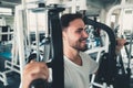 Handsome Man is Exercising With Pectoral Machine in Fitness Club.,Portrait of Strong Man Doing Working Out Calories Burning in Gym Royalty Free Stock Photo