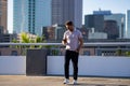 Handsome man in fashinable outfit walking on city street. Successful male model in big city living the urban lifestyle Royalty Free Stock Photo