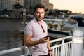 Handsome man in fashinable outfit walking on city street. Successful male model in big city living the urban lifestyle Royalty Free Stock Photo