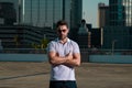 Handsome man in fashinable outfit walking on city street. Successful male model in big city living the urban lifestyle Royalty Free Stock Photo