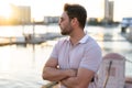 Handsome man in fashinable outfit walking on city street. Successful male model in big city living the urban lifestyle Royalty Free Stock Photo