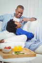 Handsome man feeding his girlfriend with strawberry Royalty Free Stock Photo