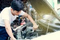 A handsome man is fixing a car for maintenance service Royalty Free Stock Photo