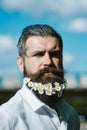 Handsome man with flowers in beard Royalty Free Stock Photo