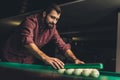 handsome man forming triangle of russian pool balls