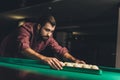 handsome man forming triangle of russian pool balls