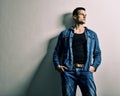 Handsome man - full jeans, thinking relies on the Wall Royalty Free Stock Photo