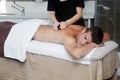 Handsome man getting massage with hot stones Royalty Free Stock Photo