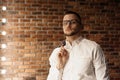 Handsome man with glasses standing near red brick wall Royalty Free Stock Photo