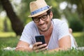 handsome man on grass texting date