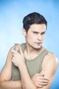 Handsome man in green tank top shaving Royalty Free Stock Photo