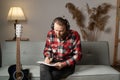 Handsome man with guitar writing lyrics or notes to music book at home studio. people, art, composition concept. Royalty Free Stock Photo