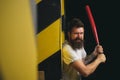 Handsome man hand holds baseball sport bat. Power and energy concept. Bearded man with baseball bat. Gangster with bat