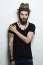 Handsome man in hat.Brutal bearded boy with tattoo